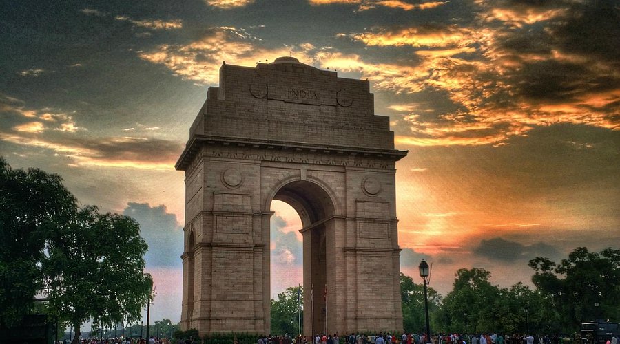 India Gate monument with a dramatic sky during sunset or sunrise.